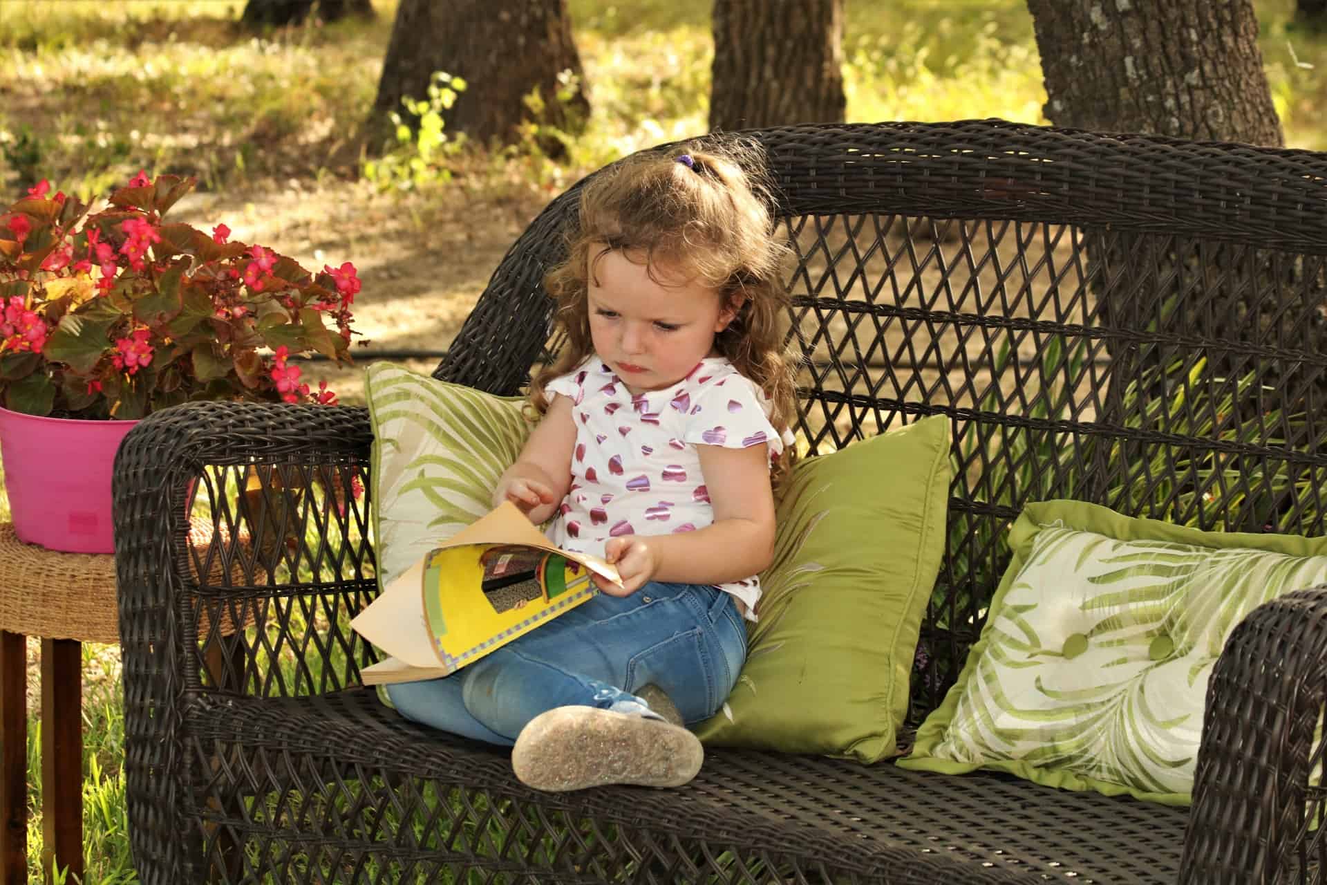 little-girl-reading-book-outside
