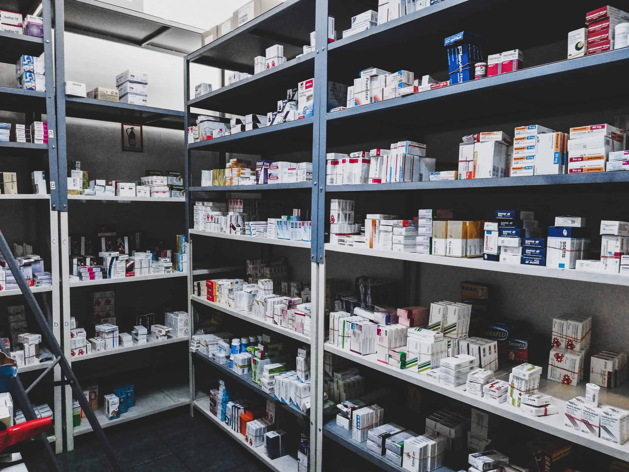 A pharmacy back room filled with shelves of supplements.