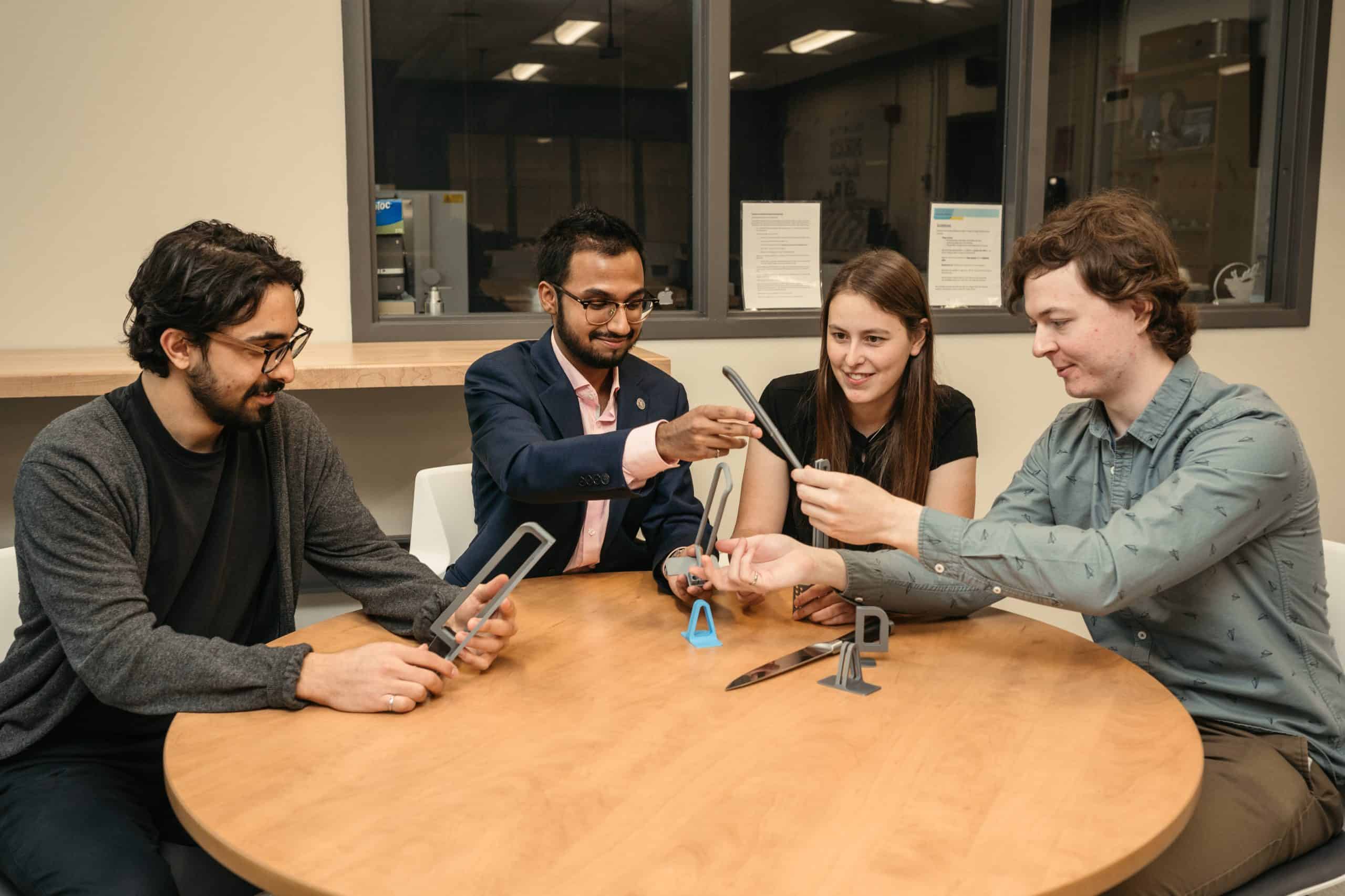 Hamilton grads win award for device that helps Parkinson’s patients use knives safely