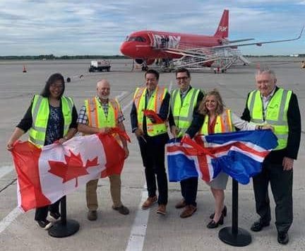 Officials cut the ribbon introducing Play's inaugural flight to Canadian travellers at John C. Munro Hamilton International Airport on Thursday, June 22, 2023. Hamilton city councillors Tammy Hwang, far left, and Mark Tadeson, second left, join Play airlines’ CEO Birgir Jónsson, middle left, Cole Horncastle, executive managing director of the Hamilton airport, middle right, Cathie Puckering, vice-president and head of Canadian Network Vantage Airport Group, right, and Ed Minich, board of director of the airport, far right. JOHN C. MUNRO HAMILTON INTERNATIONAL AIRPORT