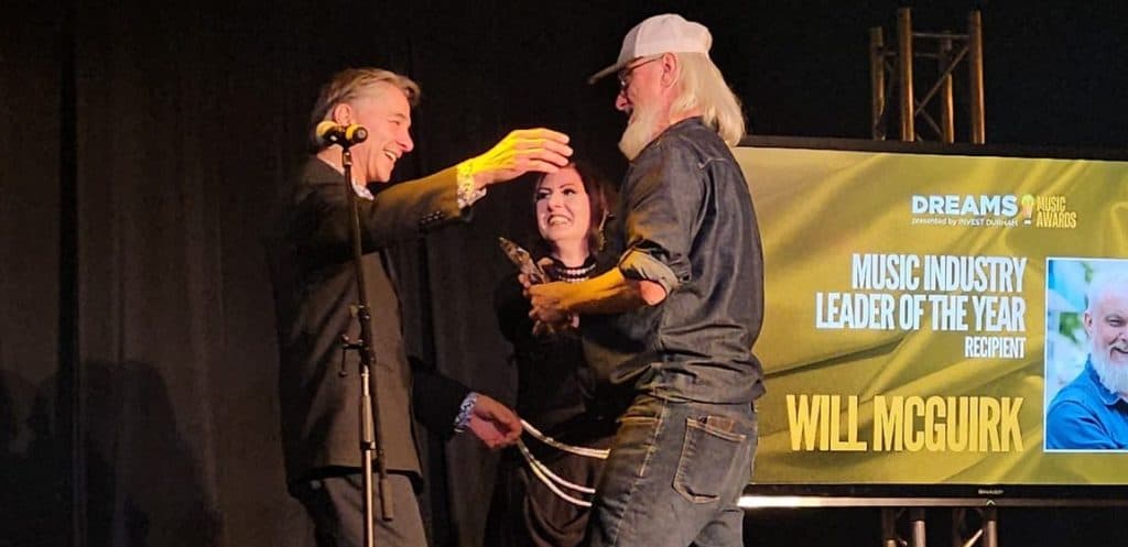 Will McGuirk accepting the DREAMS! Music Leader of the Year award n 2025