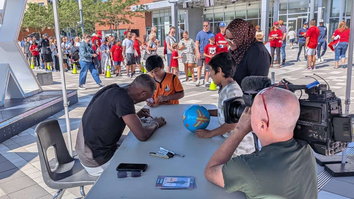 Local soccer star Derek Cornelius signing for fans at meet-and-greet in Ajax